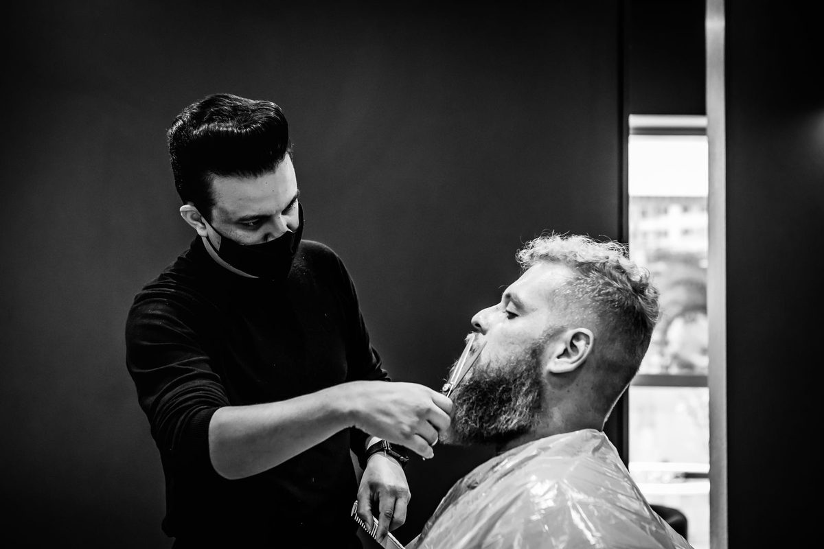Illustrative photo: barber shaping a client’s beard