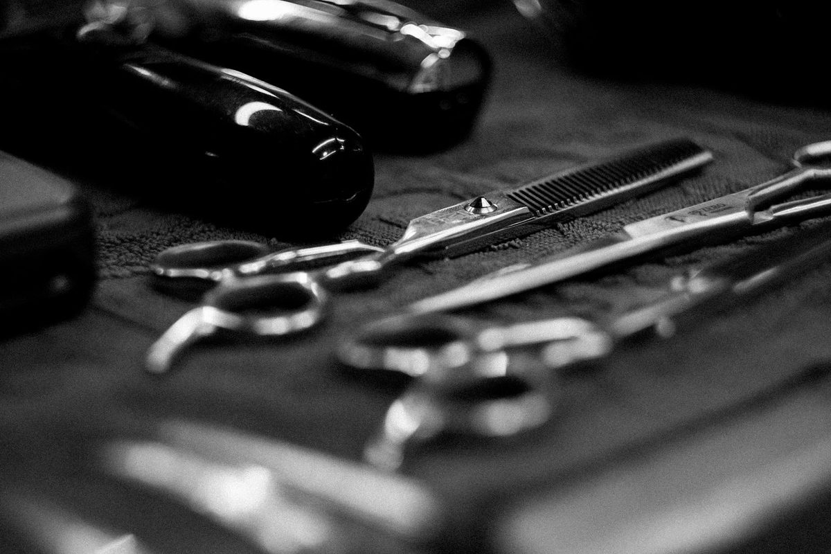 Illustrative photo: barber tools on a dark background